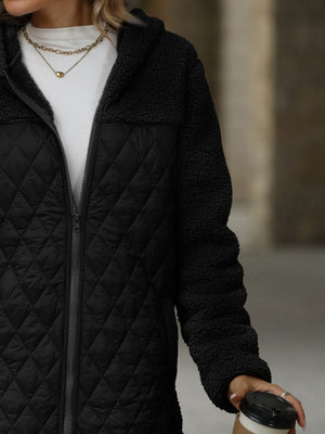 Black teddy and quilted hybrid coat with a zipper closure and hood.