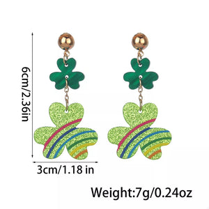 Gold dangle earrings with green glitter clover charms and colorful stripe details