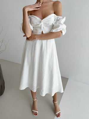 White off-shoulder midi dress with twisted bust detail, cutout, and puff sleeves.