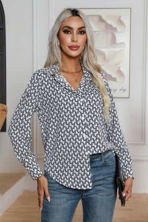 White collared blouse with black monogram print, button front, and long sleeves.