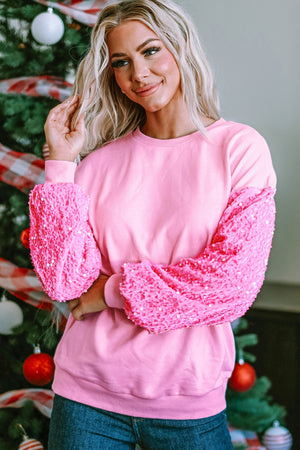 Pink cotton sweatshirt with sequin embellished sleeves and crew neck.