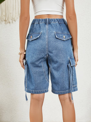 Medium wash denim bermuda shorts with button flap pockets and side cargo pockets.