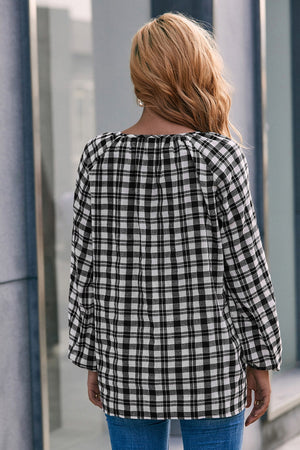 Black and white gingham blouse with gathered neckline and balloon sleeves.