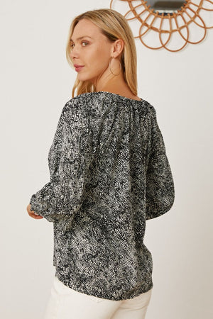 Black serpentine print blouse with gathered sleeves and a relaxed fit.