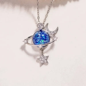 Silver celestial necklace with a cosmic orb, moon, and star charm.