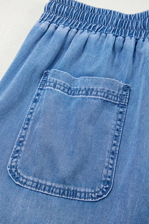 Relaxed light blue denim maternity jeans with drawstring waist and cargo pocket detail.