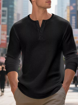 Black waffle knit long sleeve henley t-shirt with button placket detail.