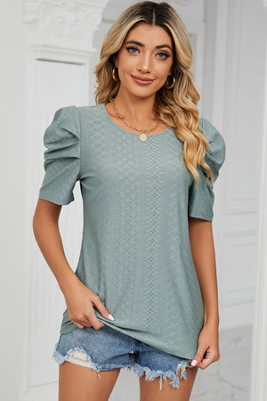 Perforated puff sleeve top in light green with a diamond pattern and round neckline.