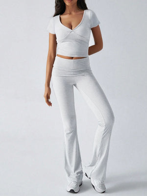 Light gray loungewear set with ruched waistband flared pants and a v-neck crop top.