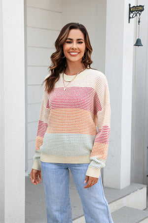Horizontal stripe waffle knit pullover sweater with crew neck and long sleeves in multicolor stripes.