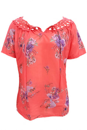 Coral floral tie-neck blouse with lace yoke and short sleeves.