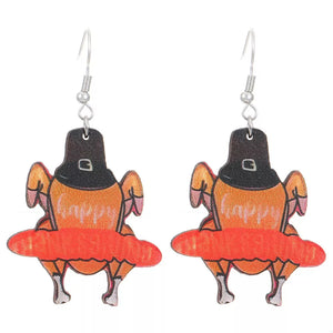 Thanksgiving turkey charm dangle earrings with pilgrim hats and orange accents.