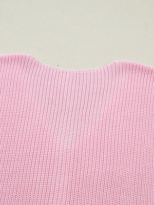 Pink acrylic sweater vest with V-neck detail and ribbed knit texture.