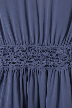 Dusty blue dress with smocked waist and textured fabric detail