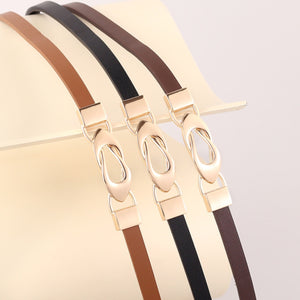 Elegant leather belts in brown, black, and caramel with interlocking gold buckles.