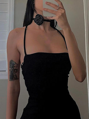 Black bodycon dress with spaghetti straps and a rose choker detail.