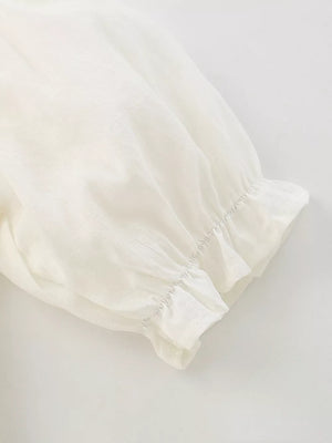 Cream cotton blend toddler dress sleeve detail with ruffled cuff