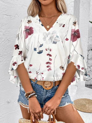 White floral blouse with lace trim and bell sleeves