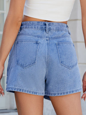 Light blue denim skort with wrap effect and angled seams, featuring back pockets.
