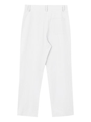 White relaxed fit sweatpants with textured fabric and a back pocket.