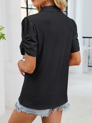 Black eyelet ruched short sleeve blouse with a collared neckline.