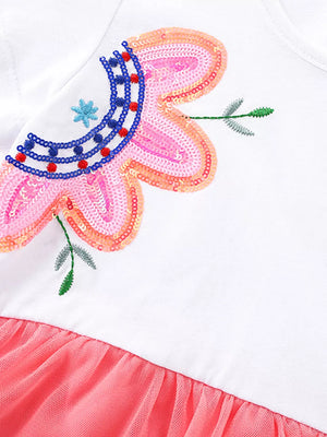 White baby dress with floral sequin embroidery and coral tulle skirt.
