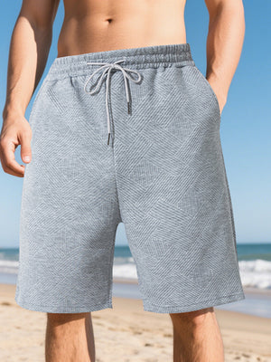 Light gray chino shorts with a geometric pattern and drawstring waist.