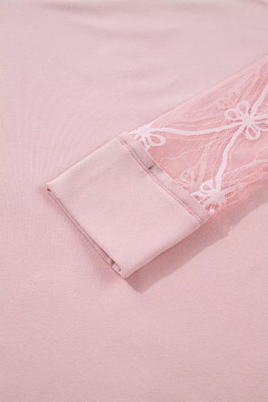 Pink maternity t-shirt with lace sleeves featuring a floral pattern and bow detail.