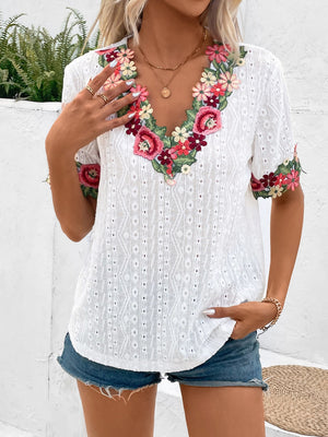 White eyelet peasant blouse with embroidered floral V-neck and sleeves