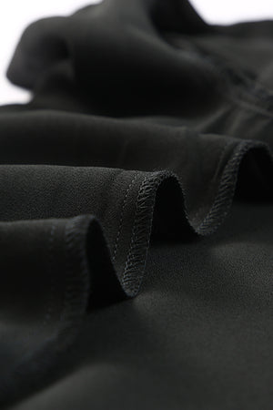 Black tie-front blouse with ruffled sleeves and a button-down front.