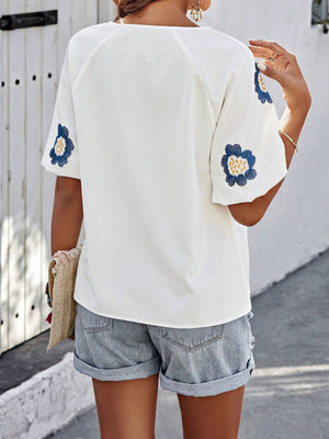 White short sleeve blouse with embroidered blue floral yoke detail