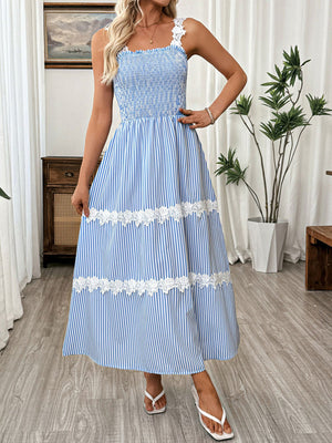Blue striped midi dress with smocked bodice and lace trim details.
