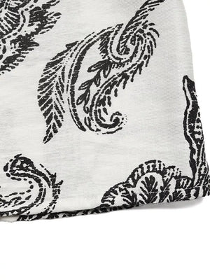 Paisley print maternity maxi dress in black and white with ruffled hem detail.