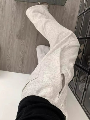 Gray wide-leg sweatpants with adjustable drawstring and pockets.