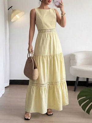 Yellow sleeveless maxi dress with lace trim at the waist and hem.