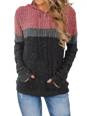 Color block ribbed knit hoodie with pink, gray, and black panels and thumbhole cuffs.
