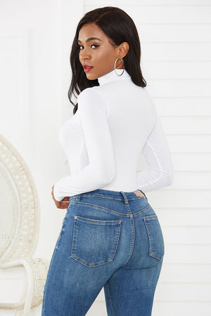 White long sleeve turtleneck thong bodysuit with a thong back.