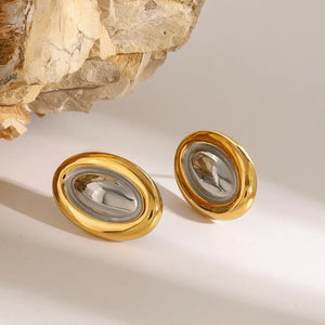 Gold two-tone oval statement earrings with a polished finish and textured center.