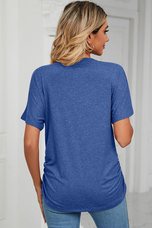 Royal blue tee with short sleeves, V-neck, and side ruching detail.