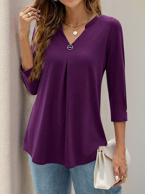 Violet V-neck three-quarter sleeve top with front pleats and a decorative button detail.