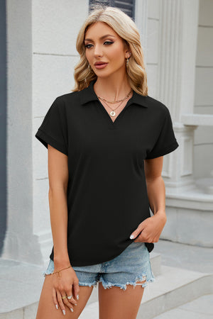 Black textured polo top with v-neck and cuffed short sleeves