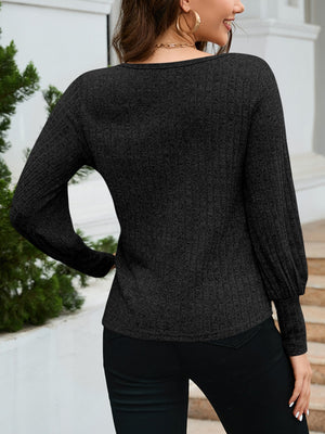 Black scoop neck knit sweater with balloon sleeves and ribbed texture.