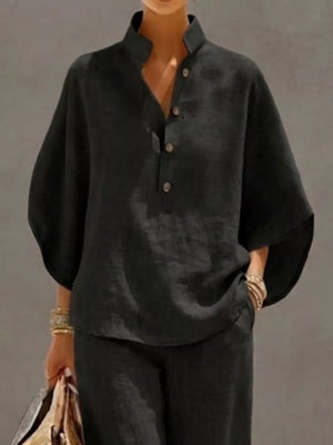Black button-down loungewear set with a stand collar and wide sleeves.