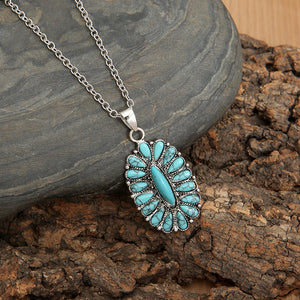 Southwestern turquoise cluster necklace with teal stones and silver chain.