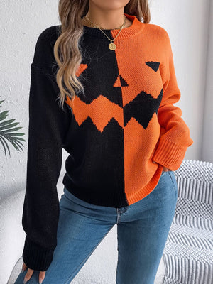 Split-face pumpkin knit sweater in orange and black acrylic with crew neck.