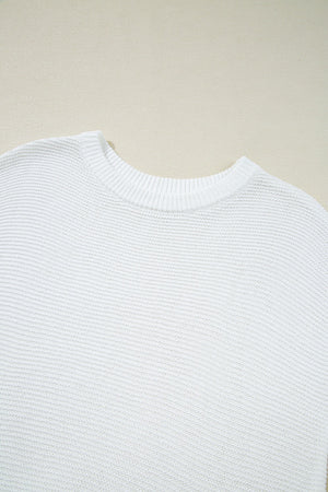 White boxy knit crop top with crew neck and ribbed trim.