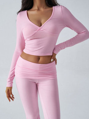 Blush pink cross-front long sleeve top and ruched waist flare pants loungewear set.