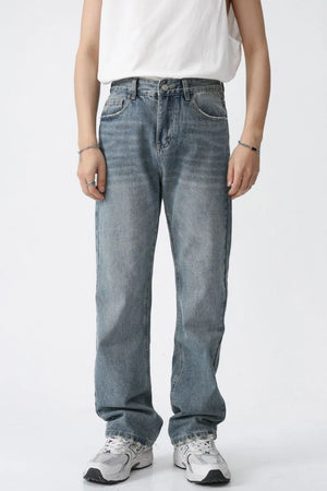 Relaxed wash straight leg denim jeans in medium blue, featuring a classic five-pocket design and a comfortable fit.