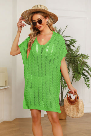 Green knit swim dress with V-neck and short slit sleeves, featuring a textured pattern.