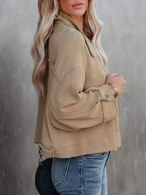 Camel waffle knit cropped utility jacket with button cuffs and frayed hem detail.
